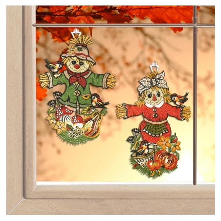 Ein Paar grüner Fensterbehänge mit Vogelscheuchenmotiv von ANDEA design sorgen mit ihrer detailreichen Vogtländischen Spitze für herbstlichen Charme.