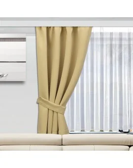 Ein beiger Vorhang ist auf der linken Seite eines Fensters zurückgebunden und gibt den Blick auf die dahinter liegenden weißen Vorhänge frei. Das Fenster befindet sich über einem cremefarbenen Sofa, und ein Teil eines gerahmten Bildes an der Wand ist auf der linken Seite zu sehen.